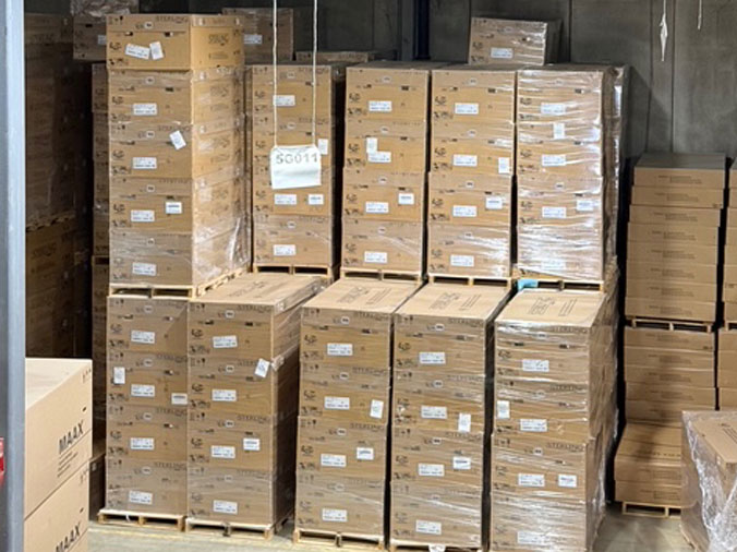 Stacke boxes of wholesale plumbing supplies in the warehouse at McDonald Plumbing Supply in Des Moines Iowa