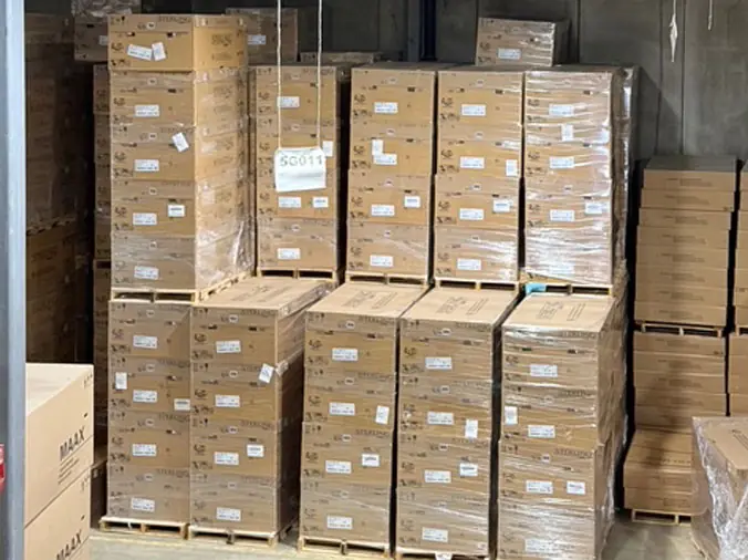 Stacke boxes of wholesale plumbing supplies in the warehouse at McDonald Plumbing Supply in Des Moines Iowa