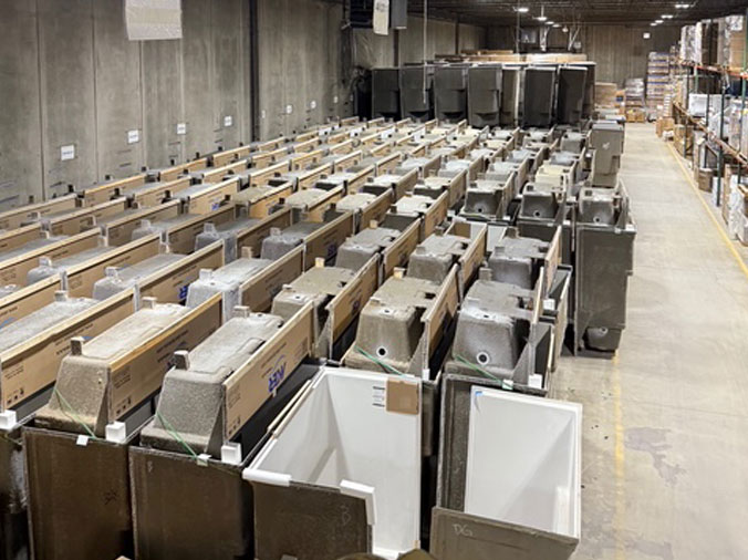 New boxed shower stalls and bathtubs in the plumbing supply warehouse at McDonald Plumbing Supply in Des Moines Iowa